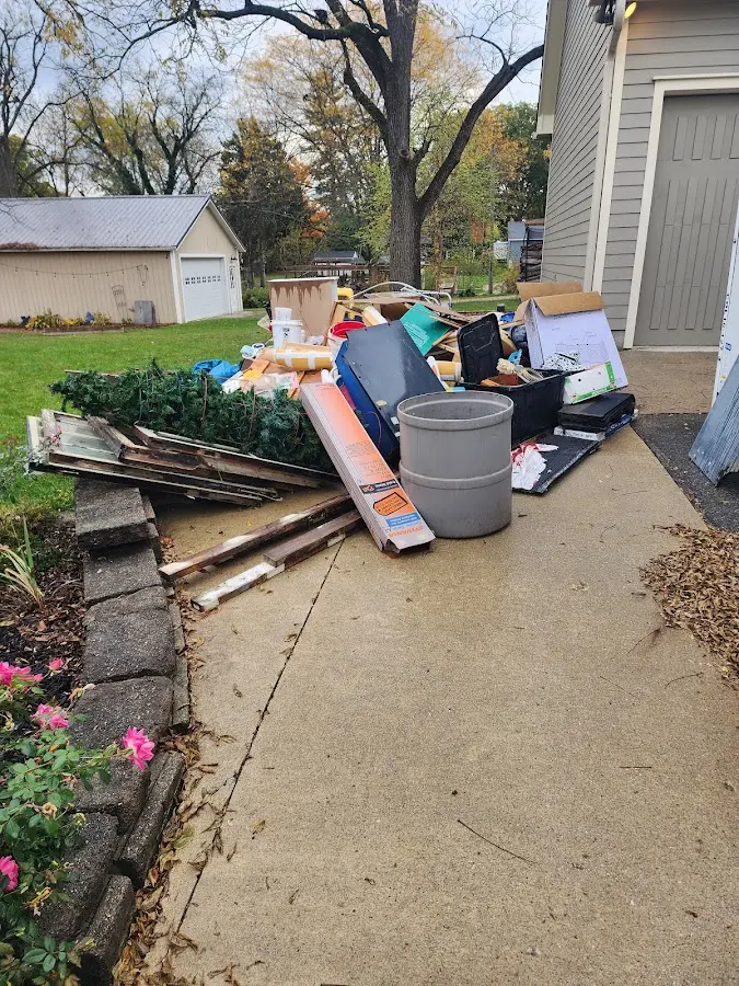 Dumpster being loaded with debris for 10 Yard Dumpster Rental in Ludington